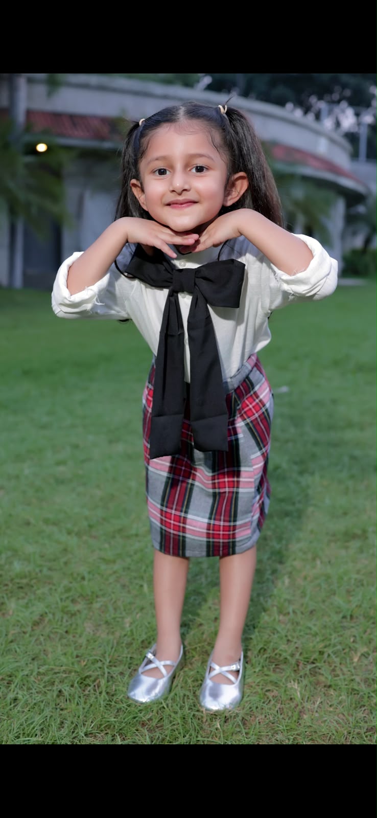 Red pleated skirt with white top and bow